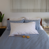 SleepFROG organic Blue duvet cover in bedroom scene with white lodge pillow